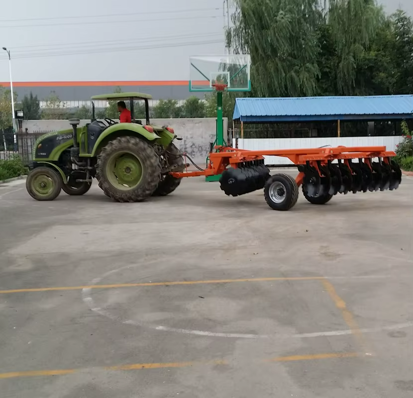 Hydraulic folding heavy duty disc harrow unfolded behind a tractor